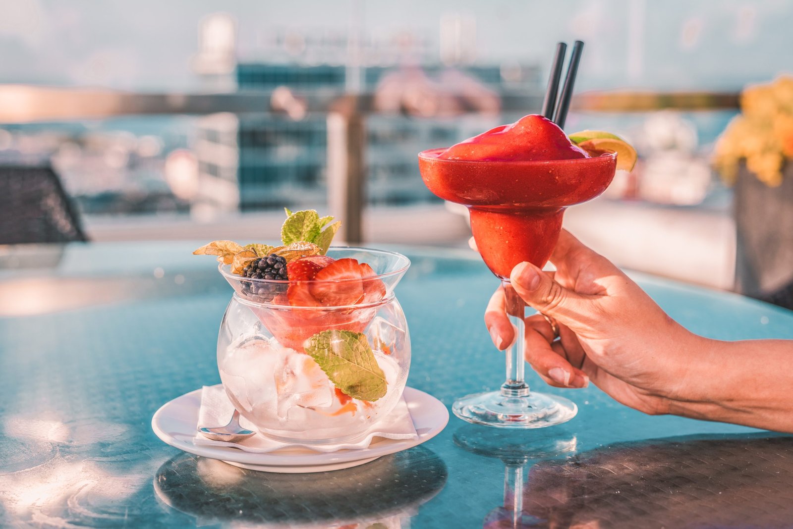 Red,Margarita,Cocktail,In,Woman,Hand,On,The,Open,Terrace