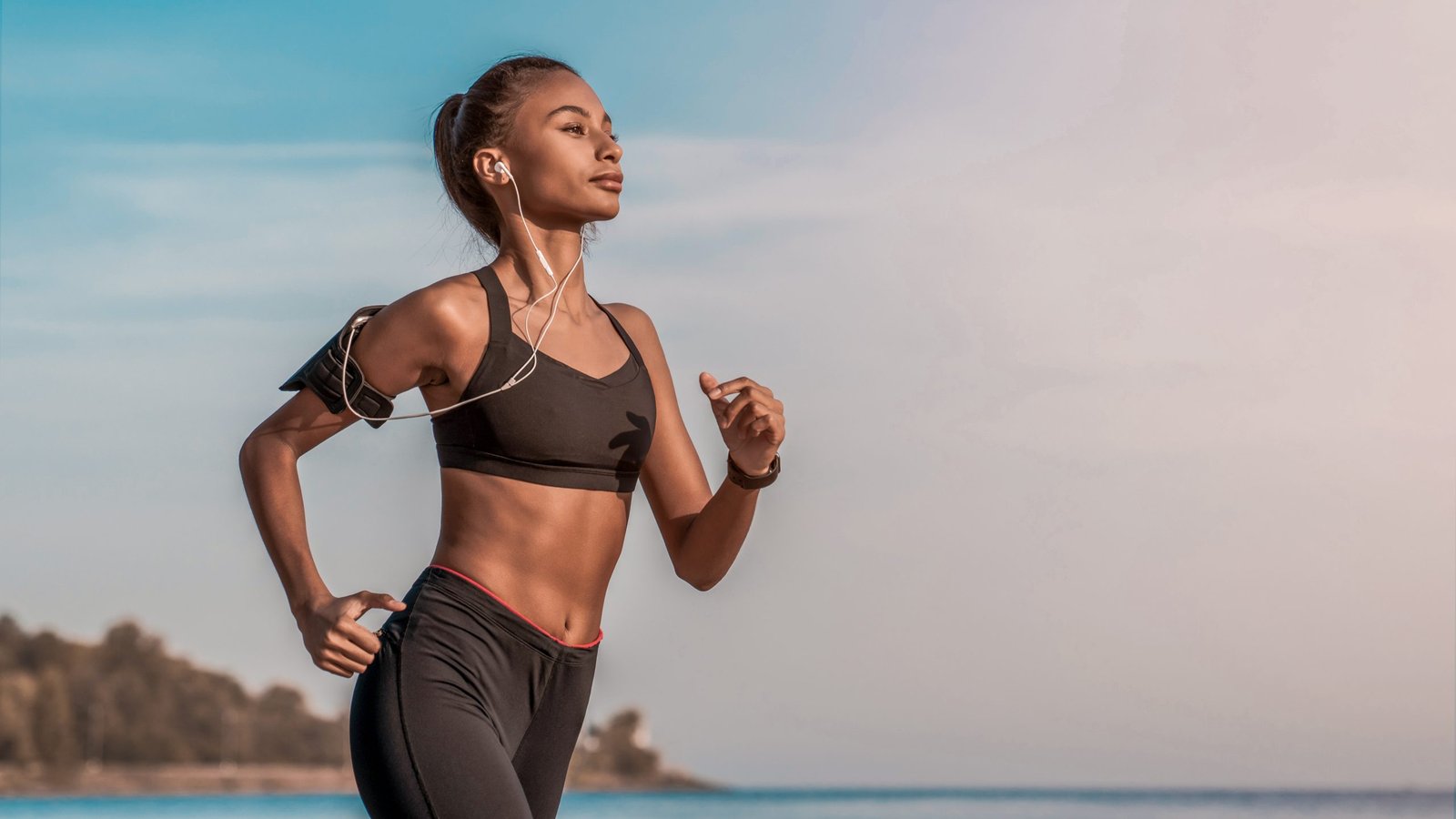 Side,View,Shot,Of,Young,Woman,In,Sportswear,Jogging,On