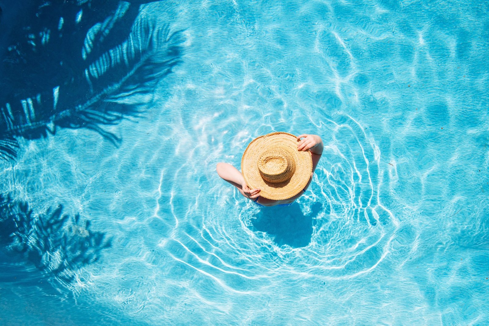 Top,View,Of,Beautiful,Woman,Earing,Sunhat,Relaxing,In,Swimming